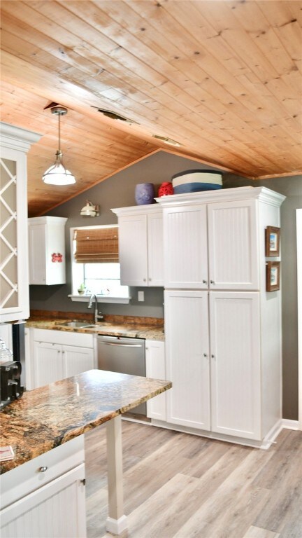 kitchen featuring wood ceiling, light hardwood / wood-style flooring, white cabinets, pendant lighting, and vaulted ceiling