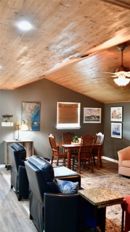 living room featuring light hardwood / wood-style floors, ceiling fan, wood ceiling, and vaulted ceiling