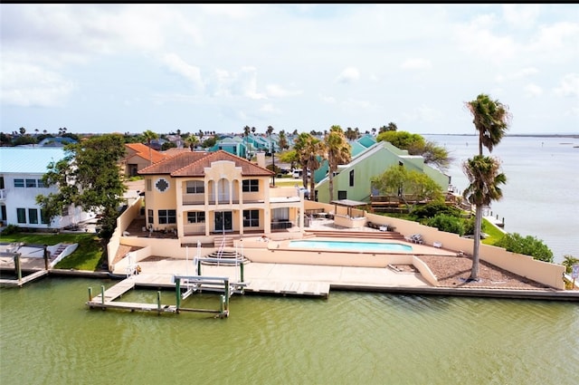 dock area featuring a patio area, a water view, and a balcony