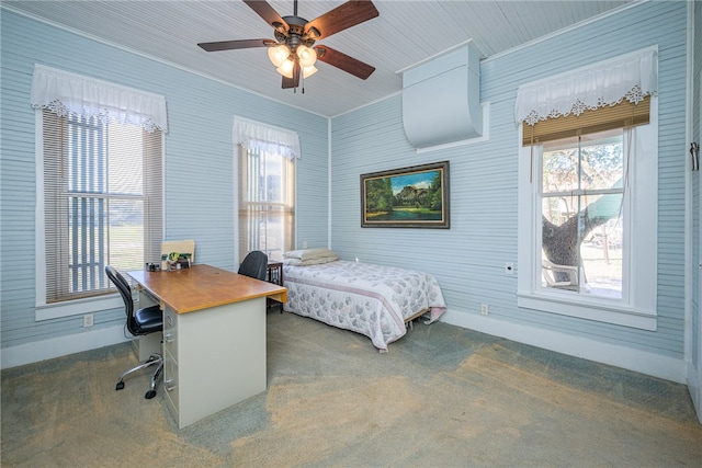 carpeted bedroom with ceiling fan and ornamental molding