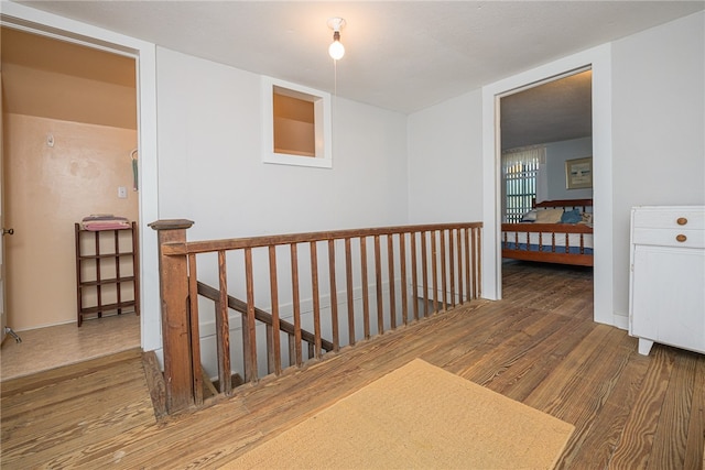 corridor with hardwood / wood-style flooring