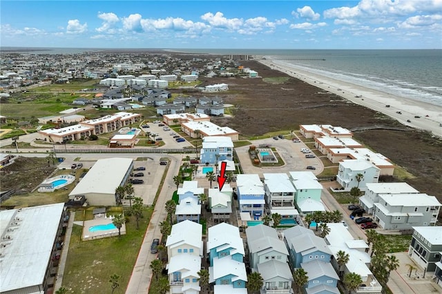 bird's eye view featuring a water view and a view of the beach