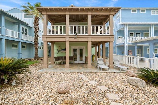 rear view of property with french doors and a patio