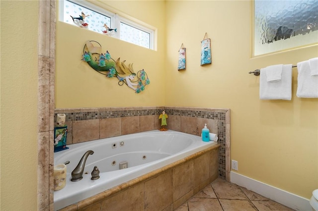 bathroom with tiled tub and tile patterned flooring