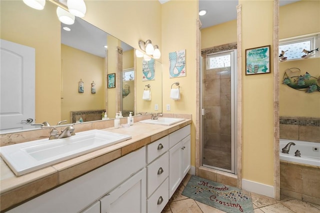 bathroom featuring shower with separate bathtub, vanity, and tile patterned floors