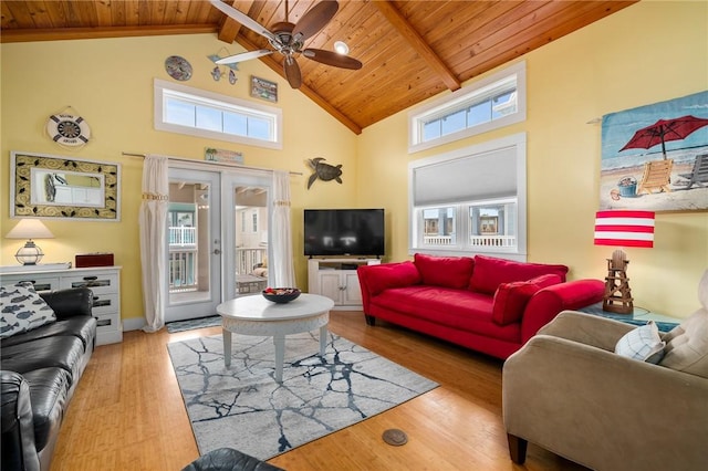 living room with beamed ceiling, wood ceiling, and light wood-type flooring