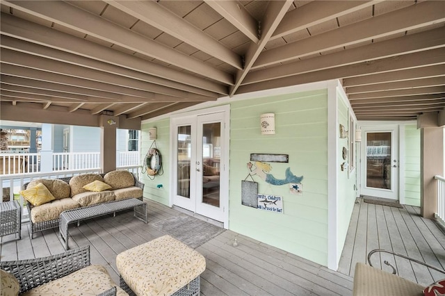 wooden deck with outdoor lounge area and french doors