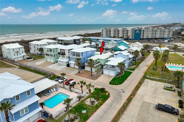 bird's eye view featuring a water view and a beach view