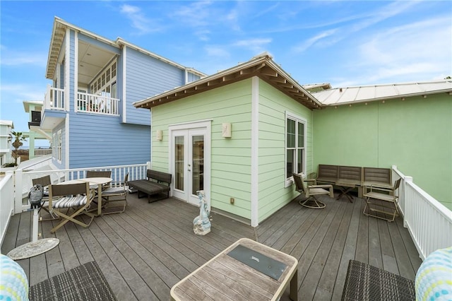 wooden deck featuring outdoor lounge area and french doors