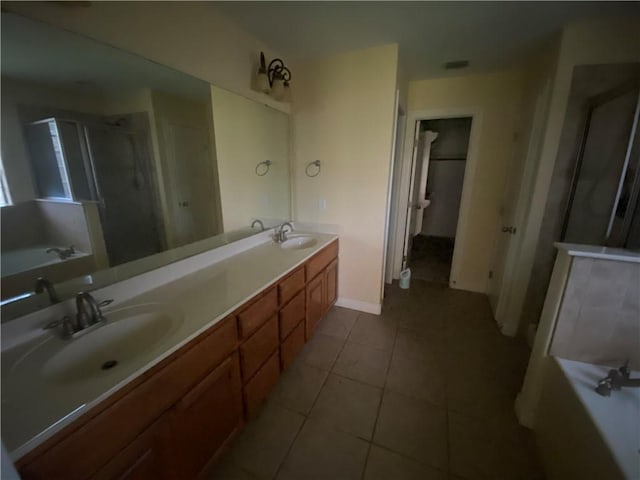 full bath with a garden tub, double vanity, a shower stall, and tile patterned flooring