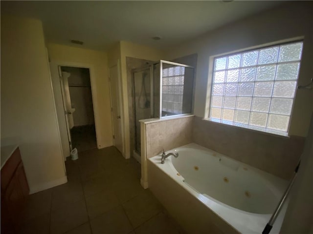 full bathroom with tile patterned floors, a tub with jets, a stall shower, and vanity