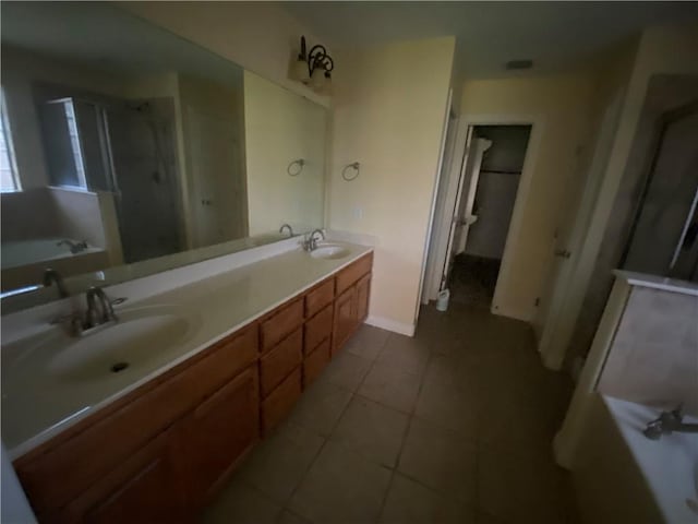 full bath featuring a bath, double vanity, tile patterned floors, and a shower stall