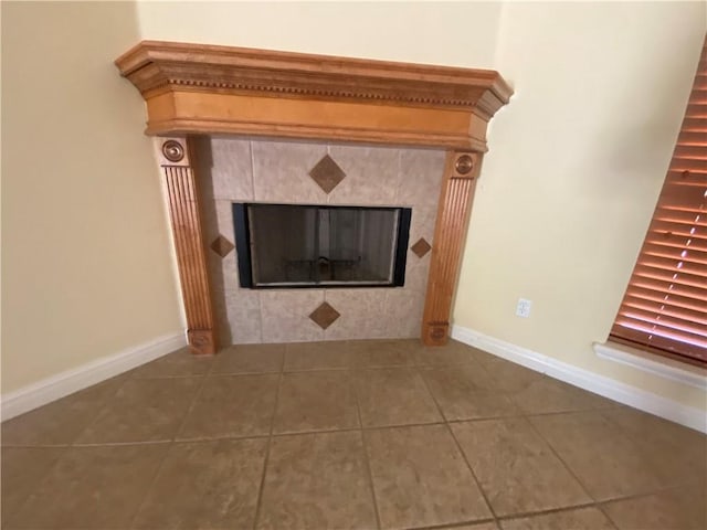 detailed view of a tiled fireplace and baseboards