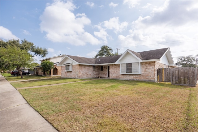 ranch-style home with a front lawn