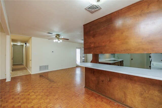 kitchen with light parquet flooring and ceiling fan