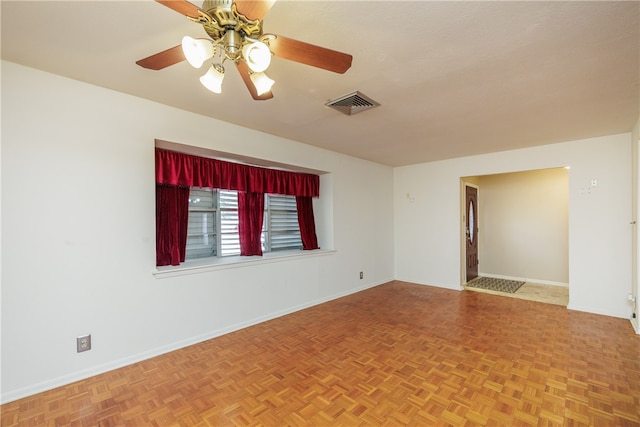 unfurnished room featuring parquet flooring and ceiling fan