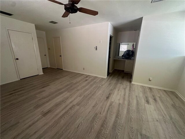 carpeted empty room with plenty of natural light and ceiling fan