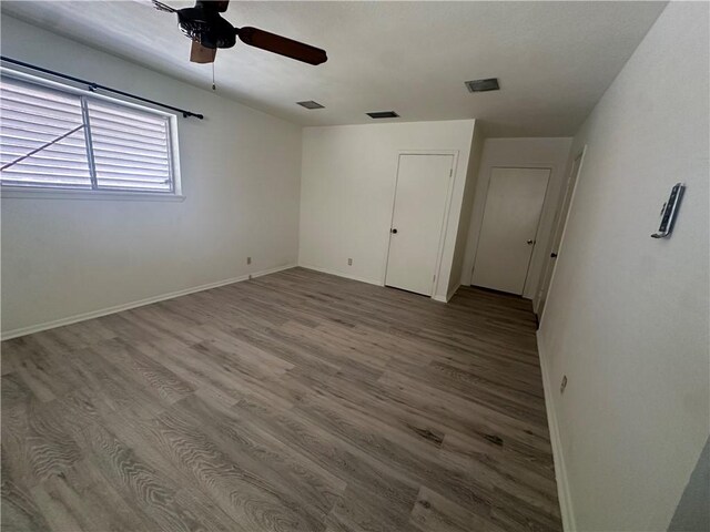 empty room with ceiling fan and carpet flooring