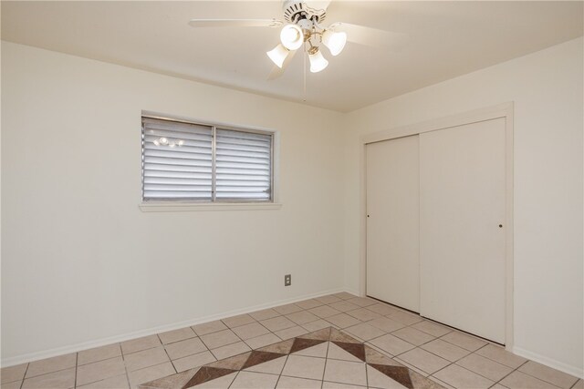 unfurnished bedroom featuring light tile patterned floors, ceiling fan, and a closet