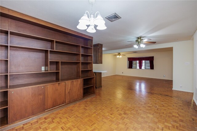 unfurnished living room with ceiling fan with notable chandelier and light parquet floors