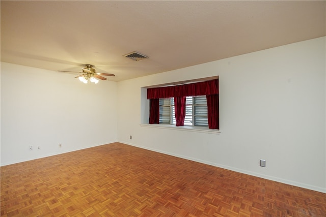 empty room with parquet flooring and ceiling fan