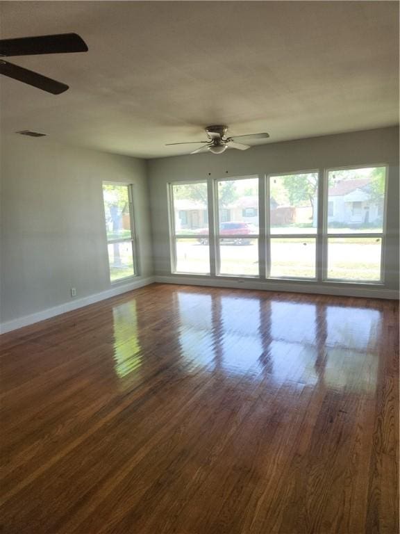 615 E Henderson St, Bishop, TX 78343 - spare room featuring baseboards, ceiling fan, and dark wood-style floors