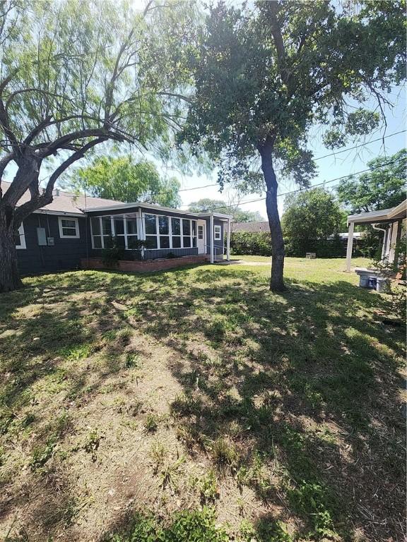 615 E Henderson St, Bishop, TX 78343 - view of yard with a sunroom