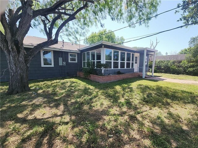 615 E Henderson St, Bishop, TX 78343 - back of property featuring a sunroom and a yard