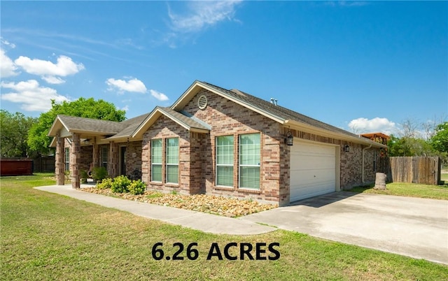 view of front of home with concrete driveway, an attached garage, fence, a front lawn, and brick siding