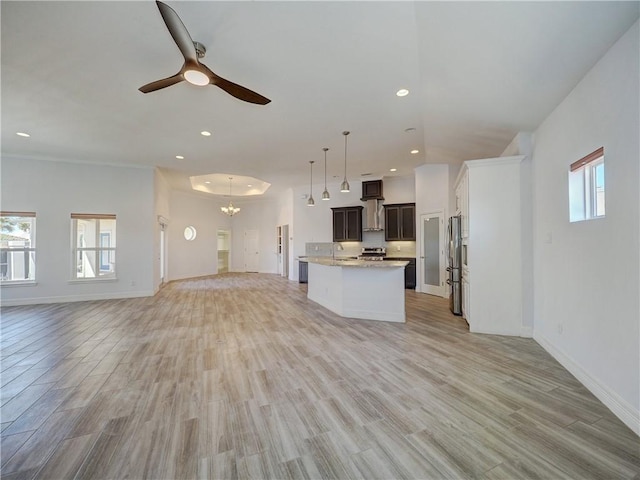 kitchen featuring open floor plan, ceiling fan, plenty of natural light, light wood-style floors, and recessed lighting