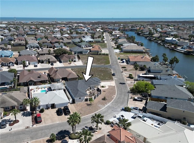 aerial perspective of suburban area with a nearby body of water