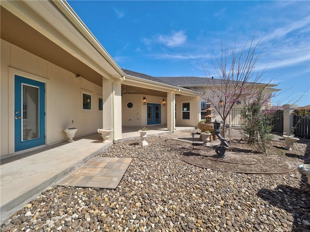 back of house featuring stucco siding, a patio area, and fence