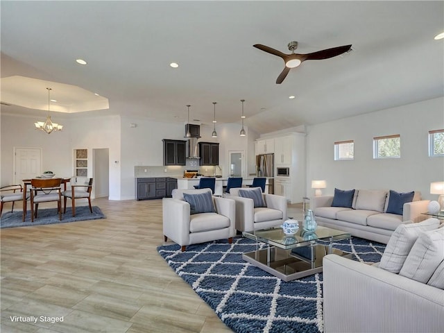 living room featuring a chandelier, ceiling fan, and recessed lighting