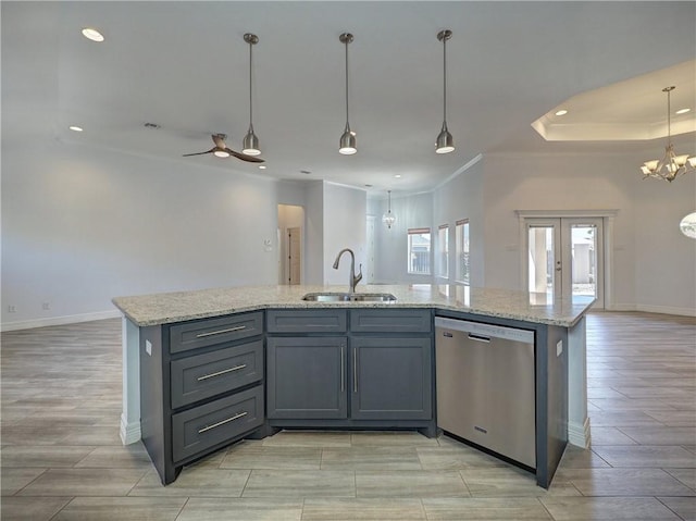 kitchen featuring stainless steel dishwasher, a sink, open floor plan, recessed lighting, and gray cabinets