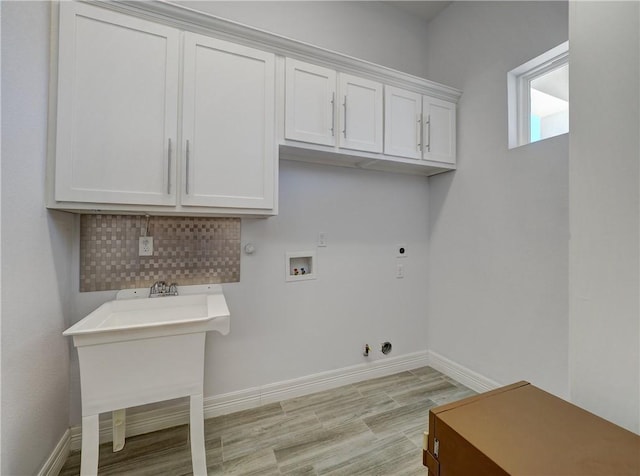 laundry area featuring gas dryer hookup, baseboards, hookup for a washing machine, electric dryer hookup, and light wood-type flooring