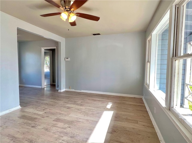 unfurnished room with light wood-type flooring and ceiling fan