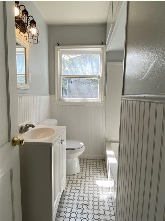 bathroom featuring tile patterned flooring, vanity, and toilet