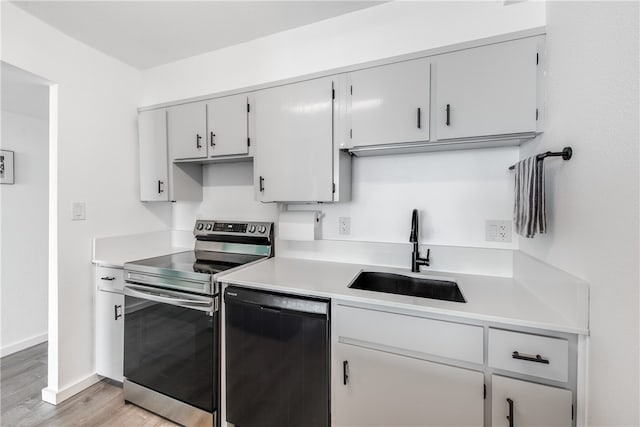 kitchen with light hardwood / wood-style floors, sink, dishwasher, and electric range