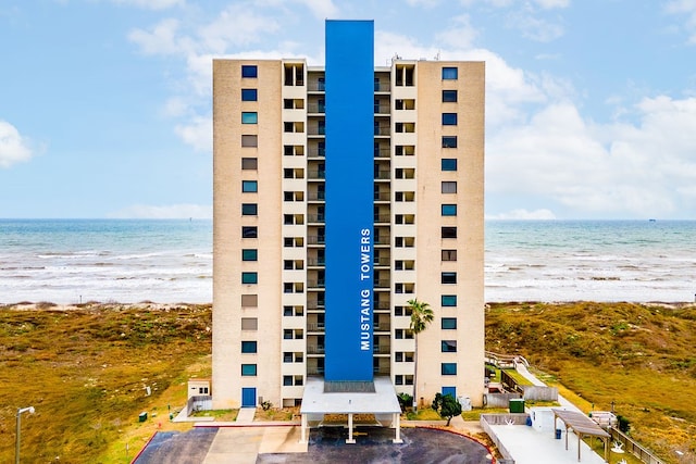 view of property with a view of the beach and a water view