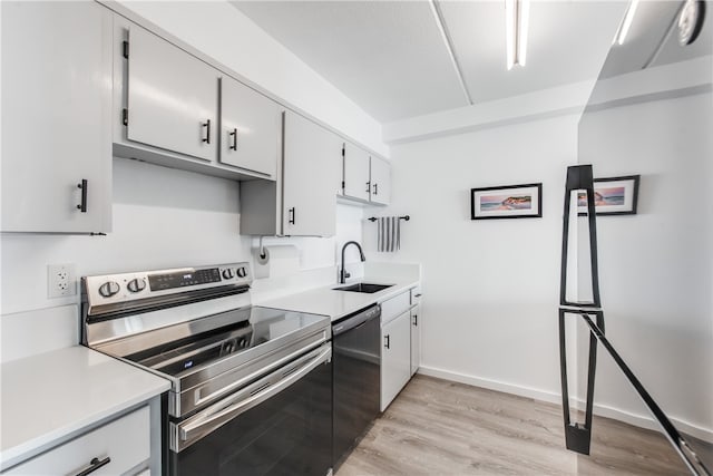 kitchen with light hardwood / wood-style floors, sink, stainless steel electric stove, white cabinets, and dishwasher