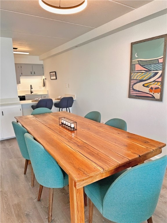 dining room featuring light hardwood / wood-style floors and sink