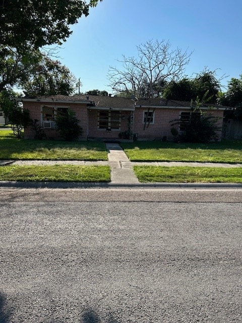 ranch-style home with a front lawn