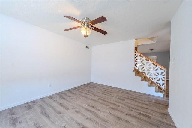 5813 Academy Dr, Corpus Christi, TX 78407 - unfurnished living room featuring wood finished floors, stairs, a ceiling fan, and baseboards