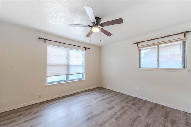 5813 Academy Dr, Corpus Christi, TX 78407 - empty room with wood finished floors, a ceiling fan, and baseboards