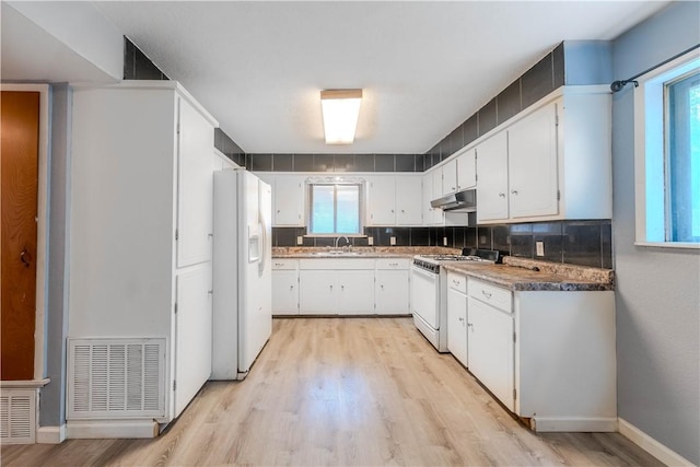 5813 Academy Dr, Corpus Christi, TX 78407 - kitchen featuring white appliances, under cabinet range hood, light wood-style floors, and a sink