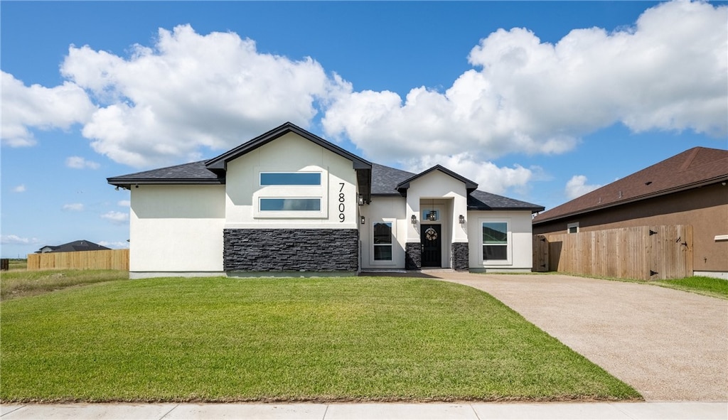 7809 Hulk Dr, Corpus Christi, TX 78414 - view of front of house with stucco siding, stone siding, driveway, and a shingled roof