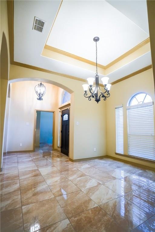 6725 Brooke Rd, Corpus Christi, TX 78414 - unfurnished room featuring arched walkways, a chandelier, marble look tiles, and crown molding