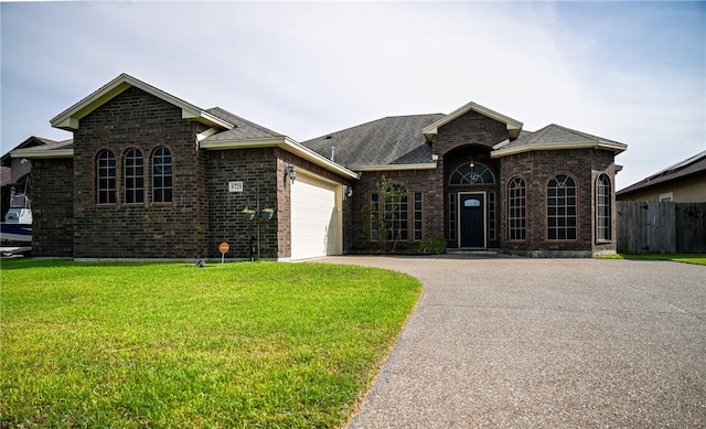 6725 Brooke Rd, Corpus Christi, TX 78414 - french provincial home with brick siding, asphalt driveway, an attached garage, and a shingled roof