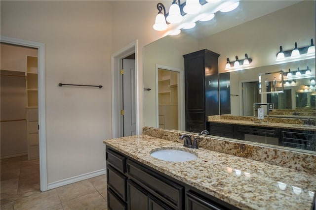 6725 Brooke Rd, Corpus Christi, TX 78414 - full bath with a walk in closet, vanity, tile patterned flooring, and a chandelier