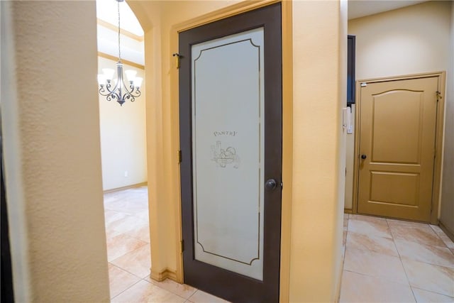 6725 Brooke Rd, Corpus Christi, TX 78414 - hallway with a chandelier and light tile patterned flooring